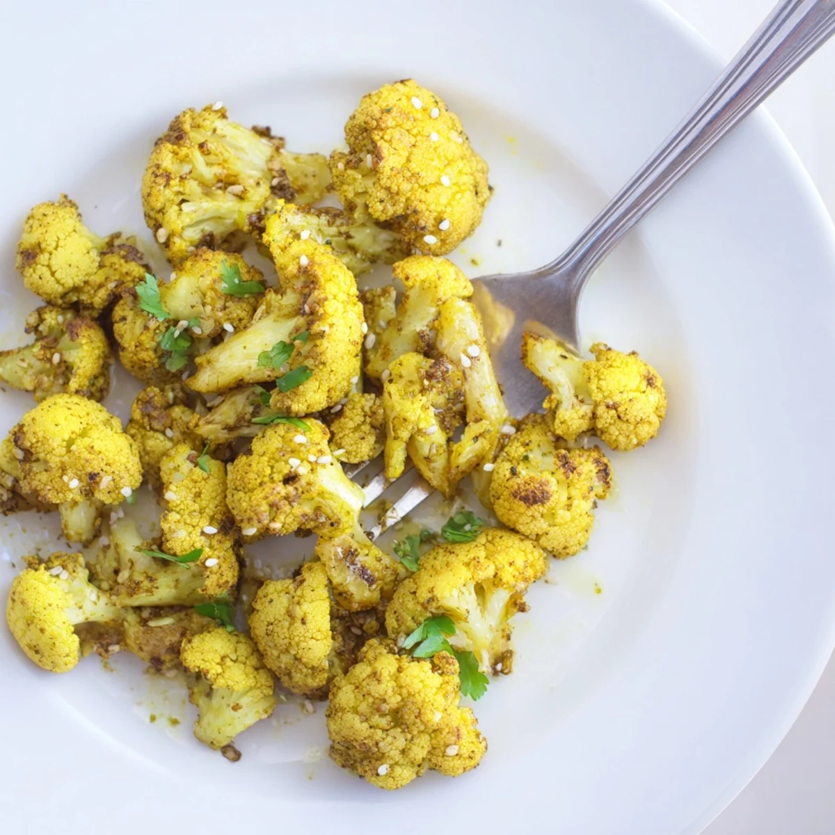 Golden Roasted Cauliflower with Turmeric is tossed in cumin and paprika, roasted until fragrant and ready to serve.