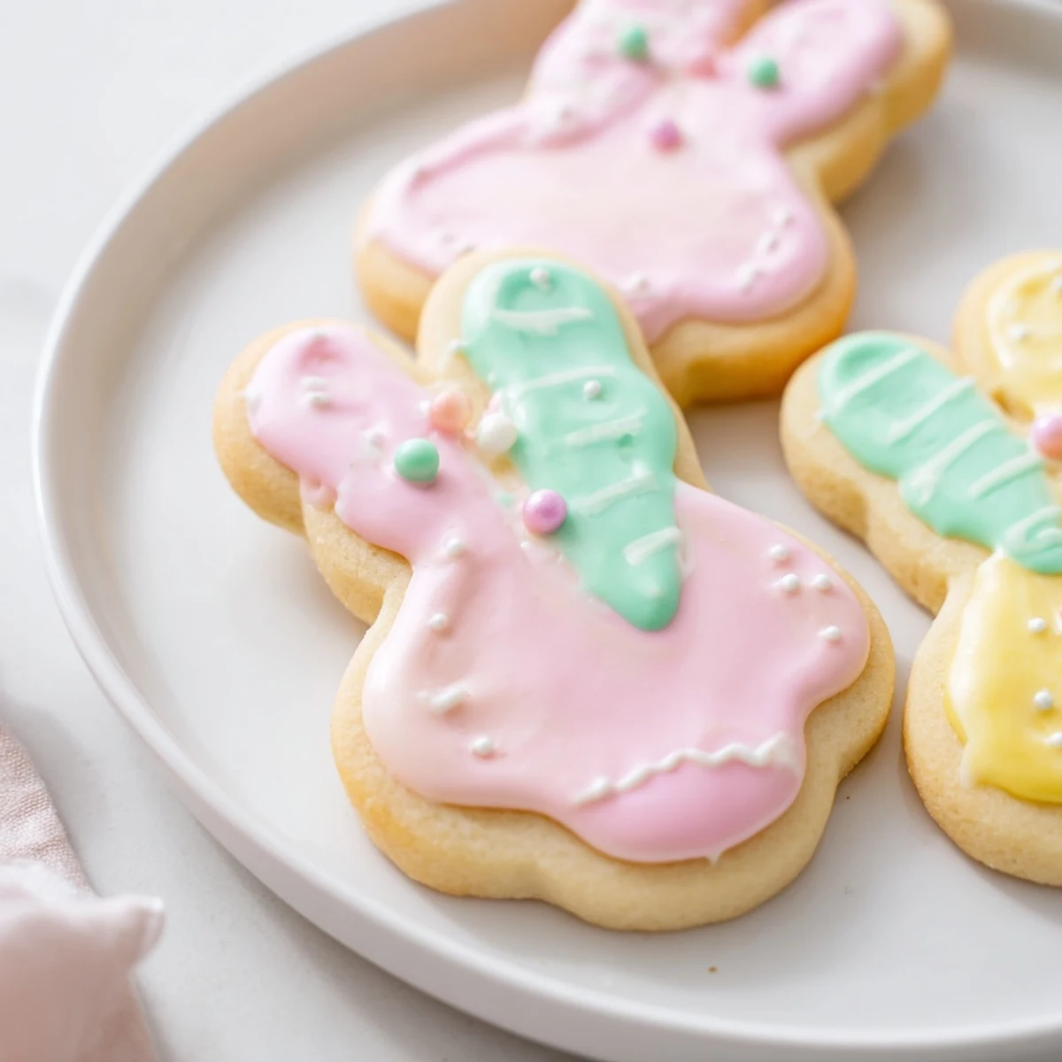 Freshly baked Easter Bunny Sugar Cookies with royal icing, arranged on a wire cooling rack after baking.