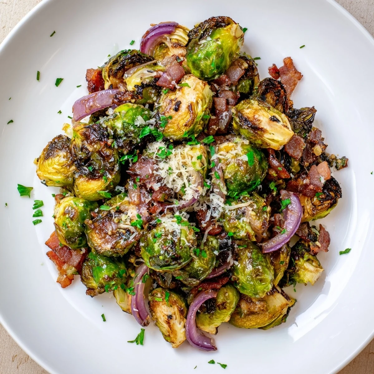 Close-up of roasted Brussels sprouts with beef bacon, showing caramelized edges and a sprinkle of Parmesan, perfect for a holiday meal.