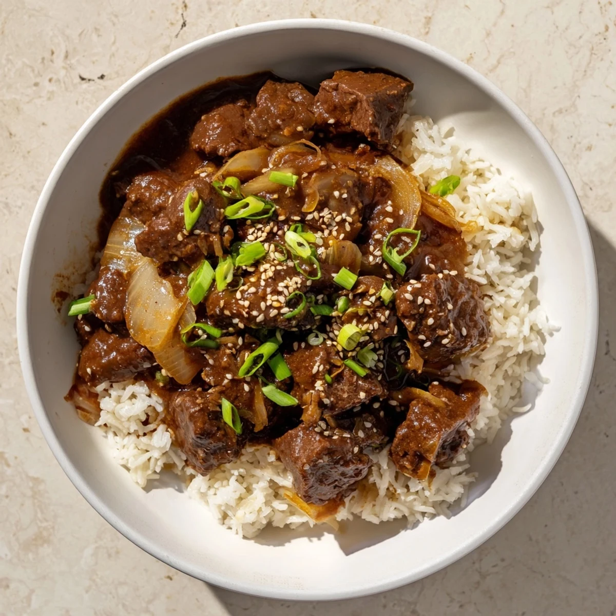 Crock Pot Korean Beef simmering in a rich sauce, garnished with sesame seeds and green onions.