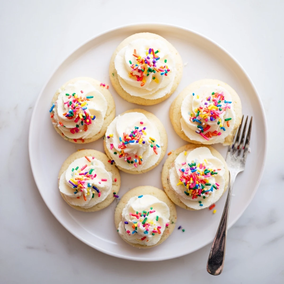 Sugary Walmart-Style Sugar Cookies with Buttercream Frosting stacked on a dessert plate, perfect for a party treat.