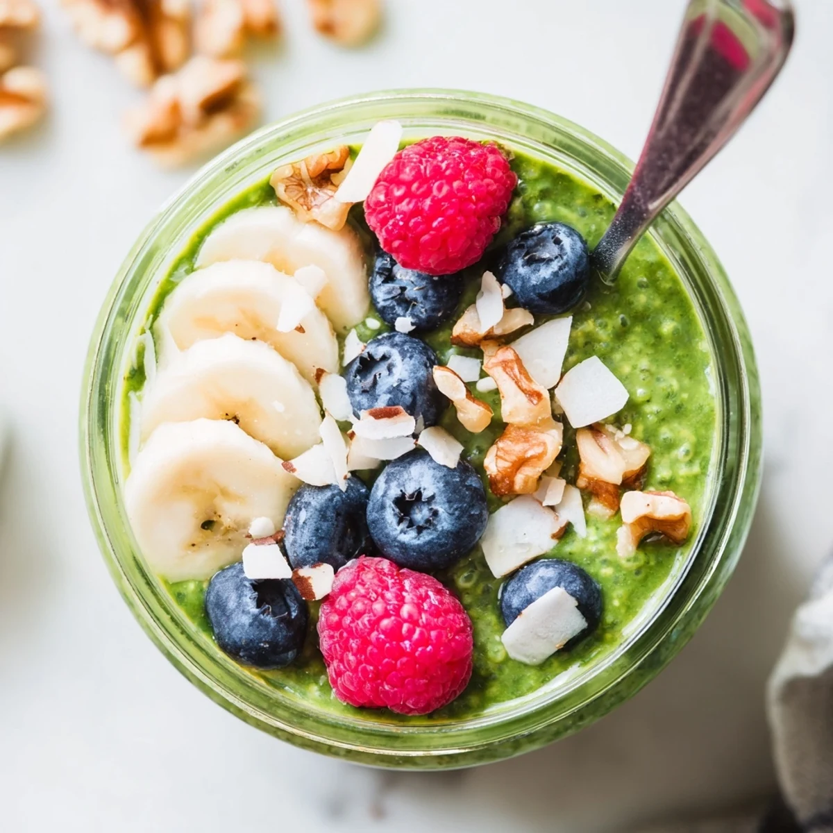 Vibrant green Matcha Protein Overnight Oats with chia seeds and creamy texture, ready to eat straight from the chilled jar.