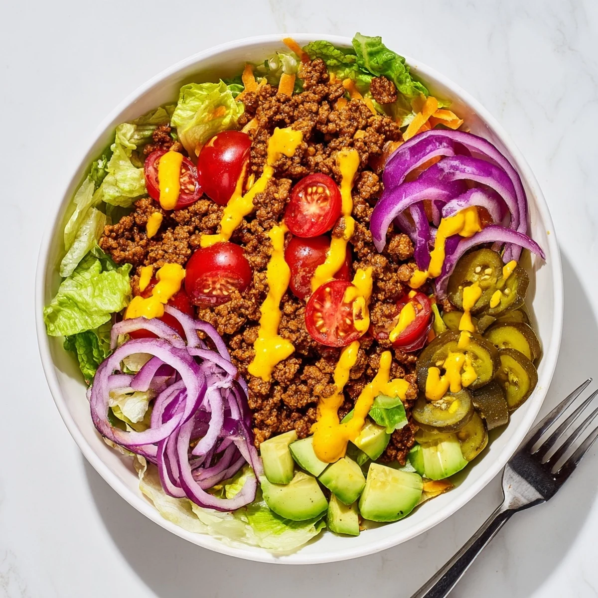 Homemade burger bowl featuring juicy spiced beef, fresh vegetables, melted cheddar cheese, and tangy special sauce arranged in colorful layers