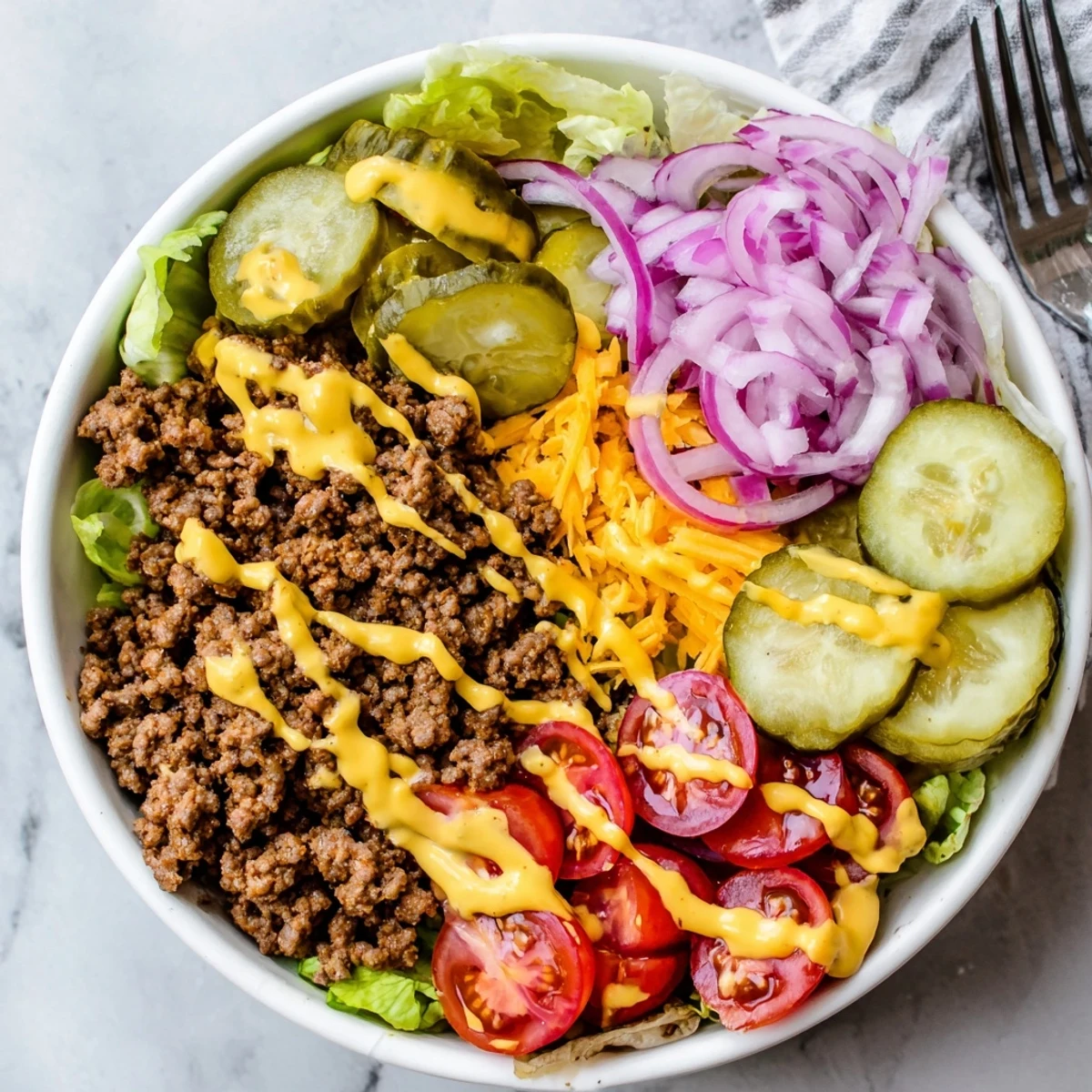 Golden seasoned ground beef served over crisp romaine lettuce with cheddar, tomatoes, pickles, and creamy burger sauce in a low-carb burger bowl