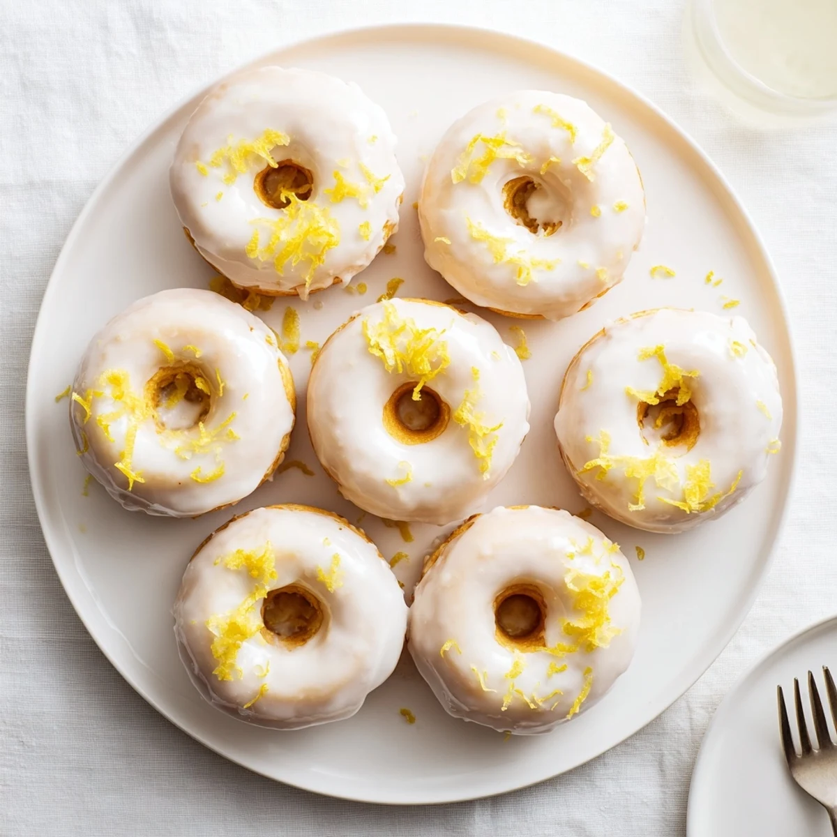 Chewy gluten-free lemon mochi donuts topped with tangy citrus icing and zest