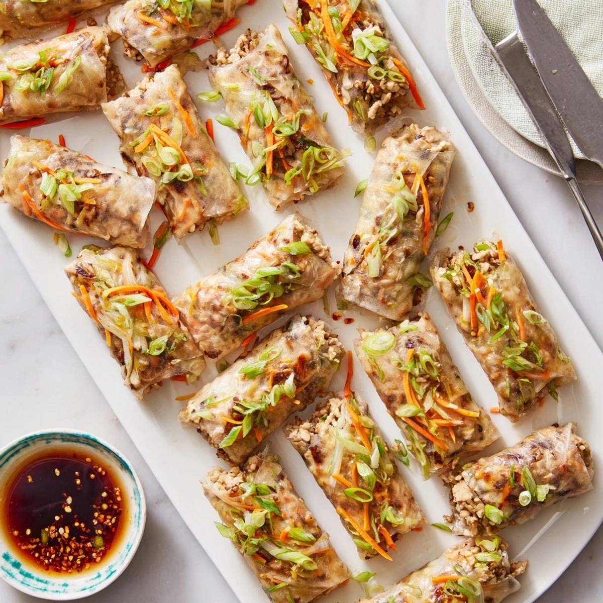 Golden crispy rice paper spring rolls with vegetable filling ready for dipping