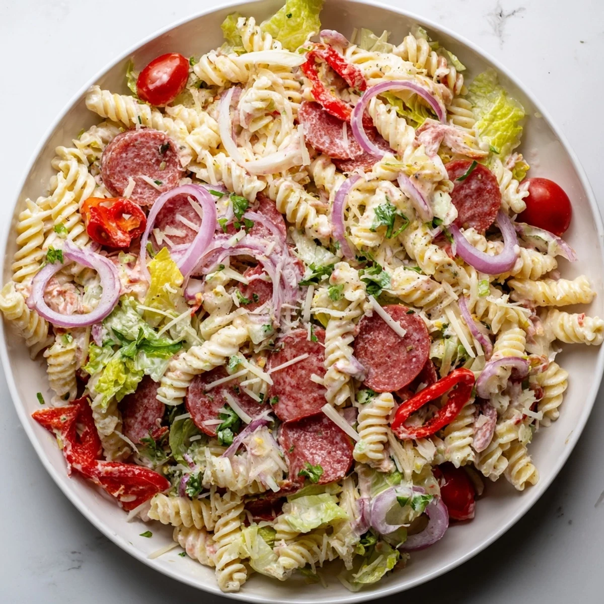 Crowd-pleasing Italian grinder pasta salad tossed with cherry tomatoes, red onion and pepperoncini peppers