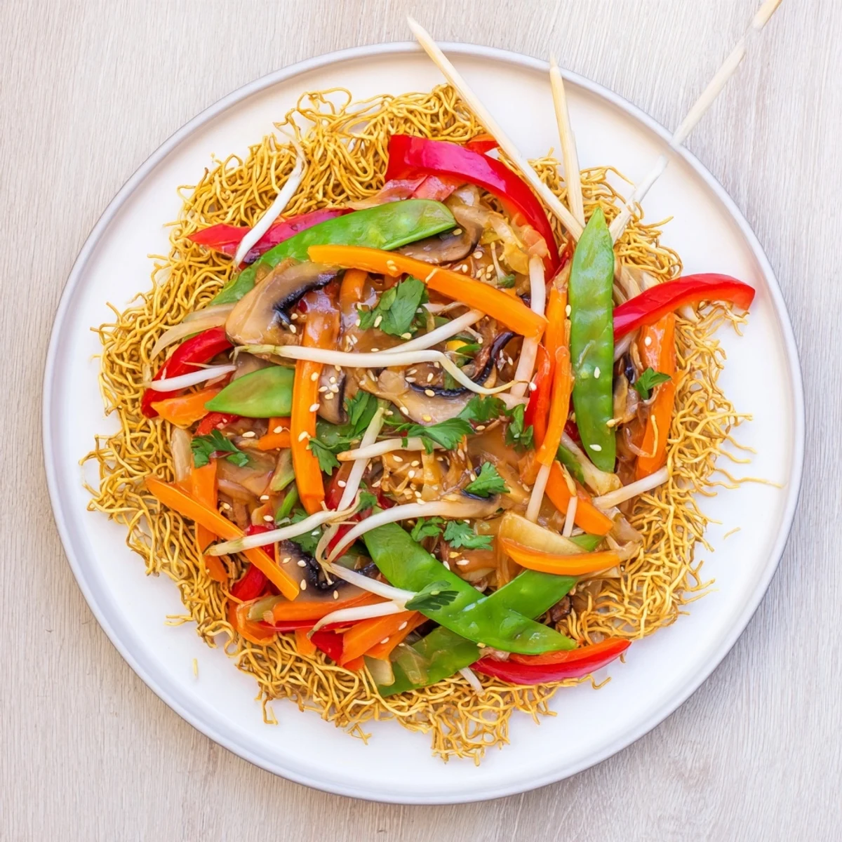 Vibrant vegetable chow mein featuring crunchy fried noodles tossed with bell peppers and snap peas