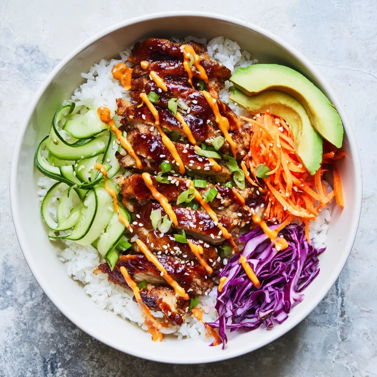 Savory Korean BBQ chicken bowl topped with creamy spicy mayo avocado and crisp vegetables