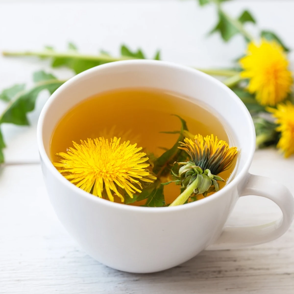 Warm cup of earthy dandelion tea garnished with lemon slice and honey on wooden table