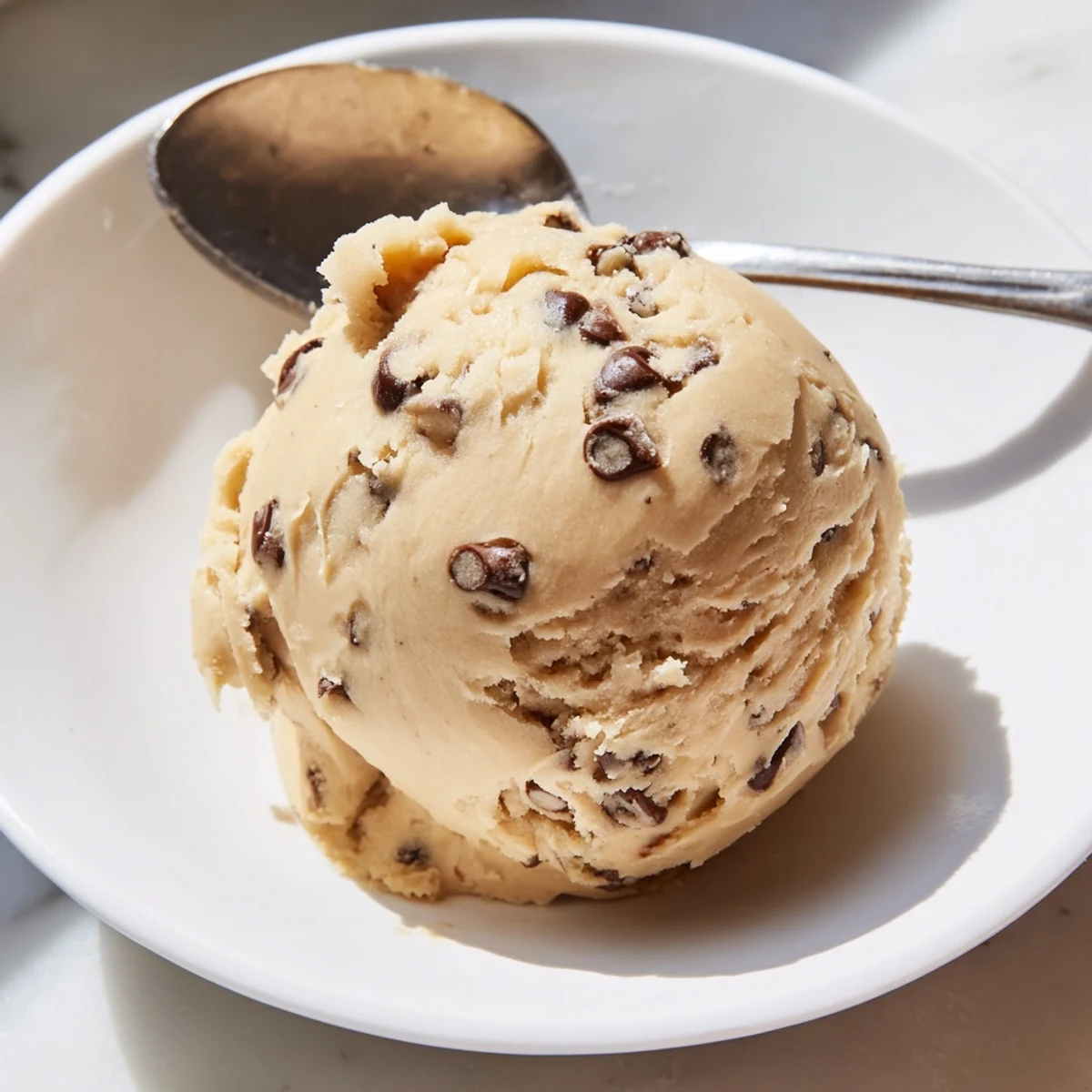 Golden chocolate chip cookie dough studded with chocolate chips ready for spooning