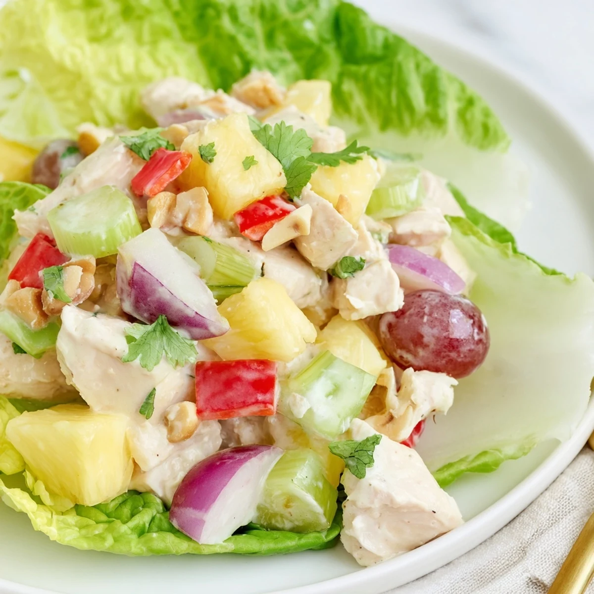 Chilled Hawaiian Chicken Salad Recipe served on butter lettuce, garnished with fresh cilantro