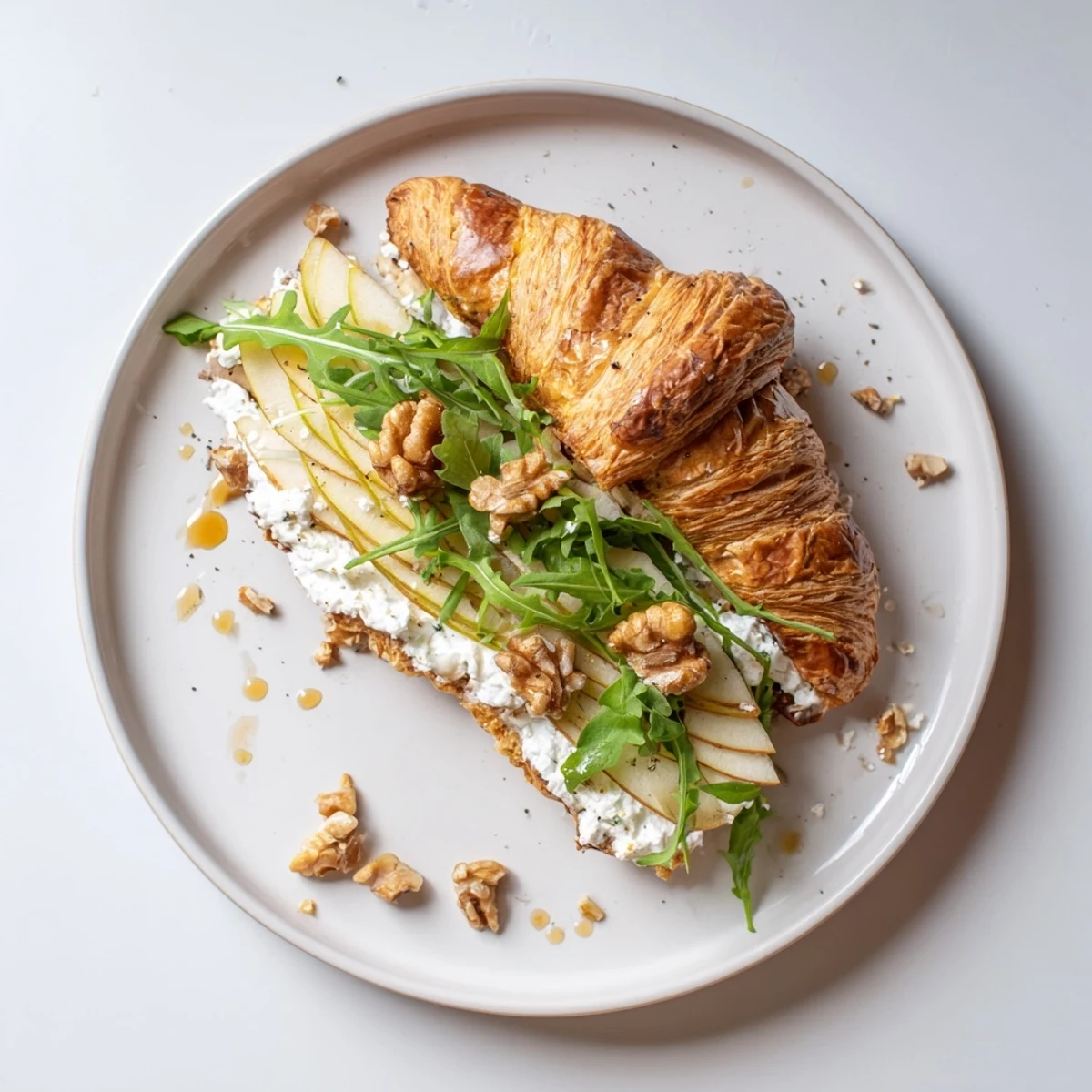 Buttery Apple Goat Cheese Croissant Sandwich with crisp apple slices and honey drizzle