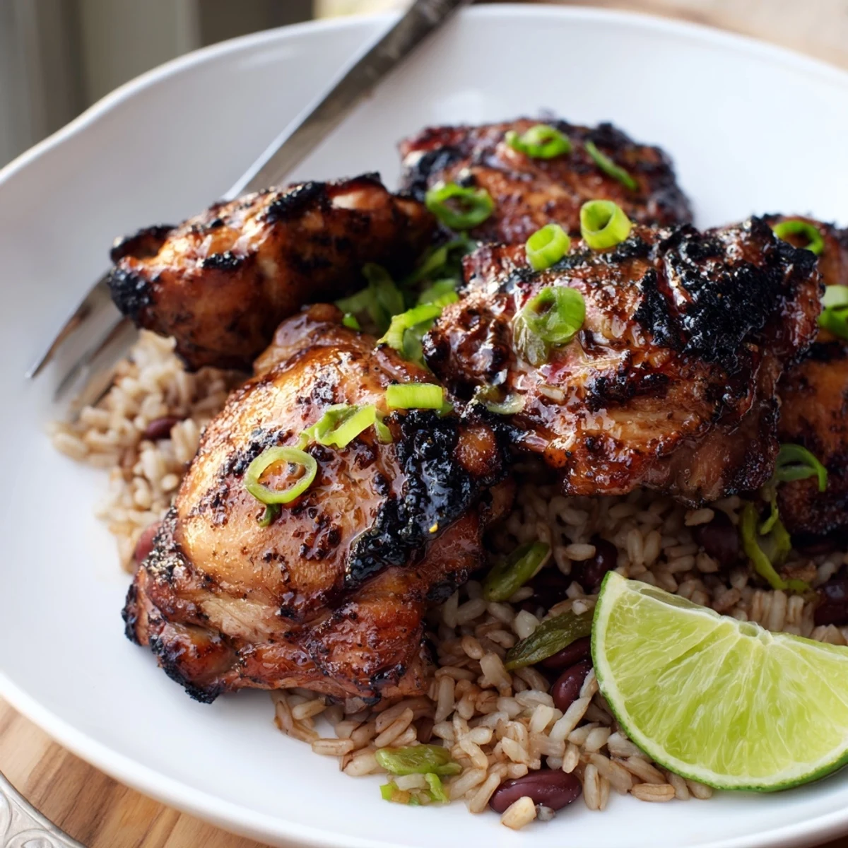 Warm plate of coconut rice topped with spicy Caribbean Jerk Chicken And Rice