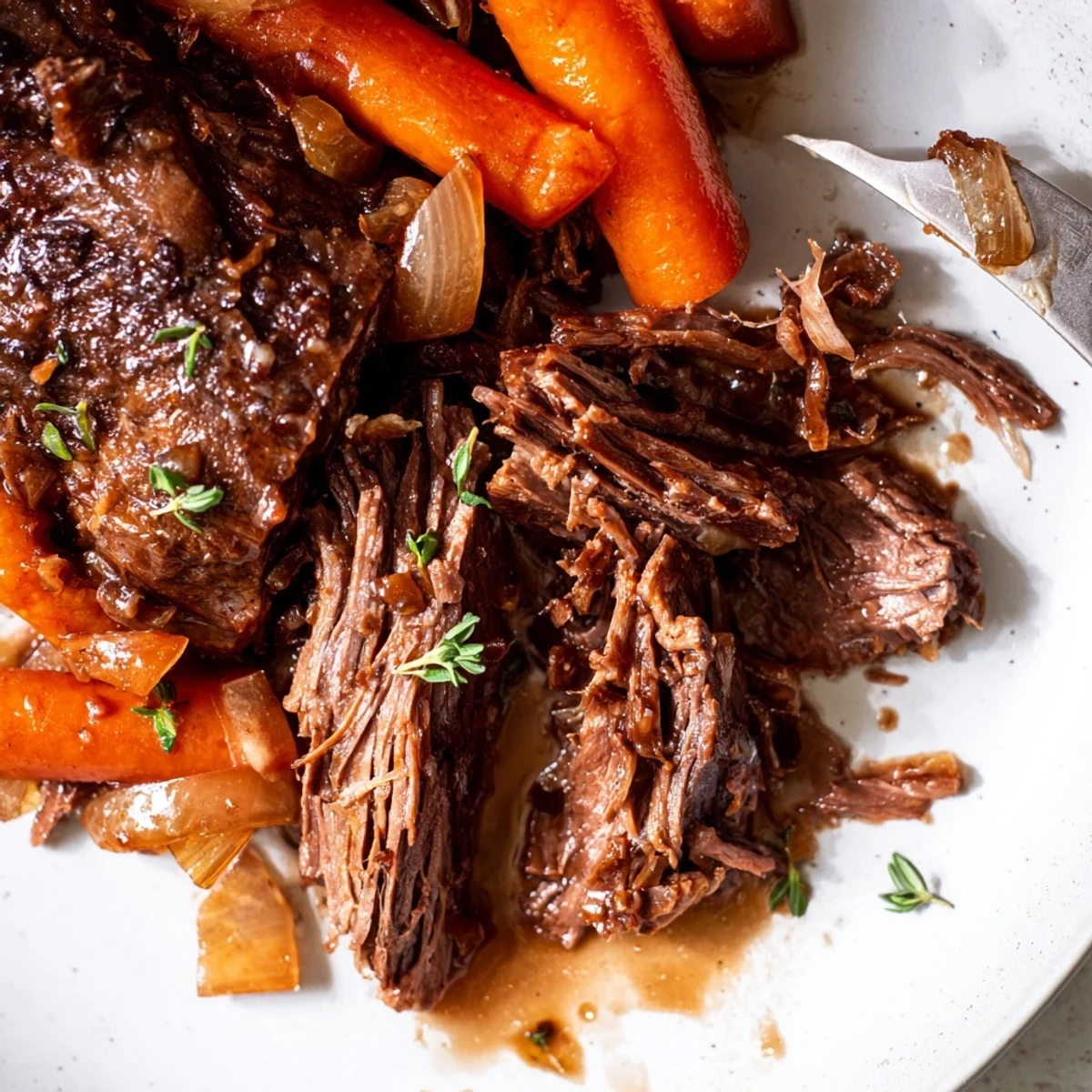 Meltingly tender herb braised beef chuck roast plated with root vegetables and gravy