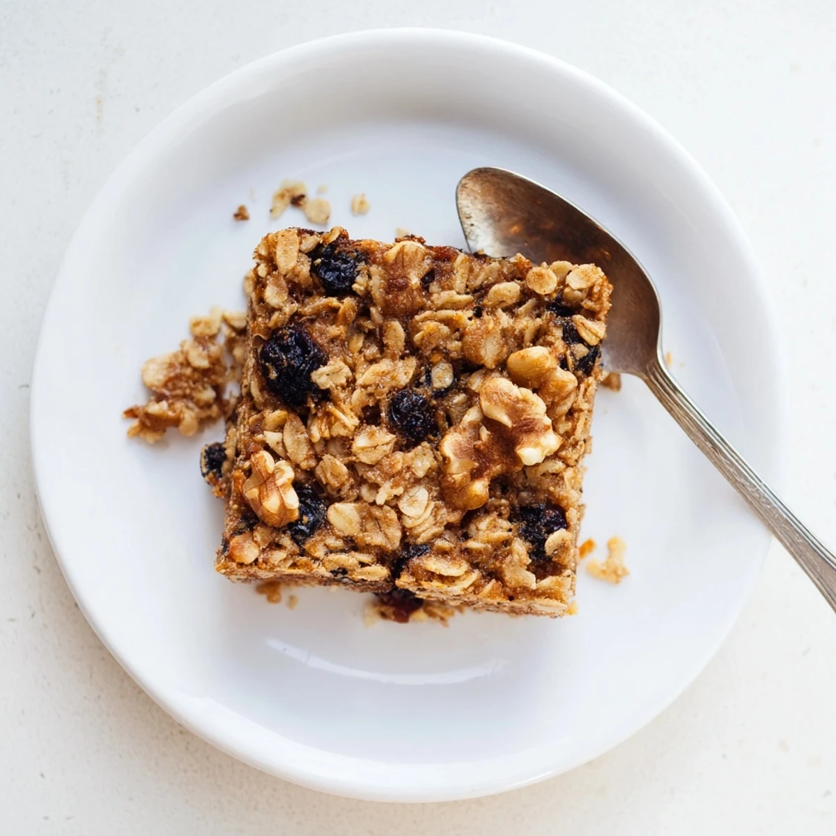 Warm baked oatmeal casserole with sliced bananas and crunchy pecan topping