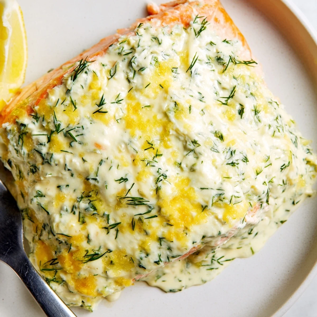 Tender baked salmon topped with melted garlic-herb Boursin cheese and bright lemon zest