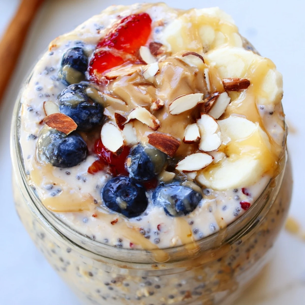 Creamy protein overnight oats topped with fresh berries in a glass jar
